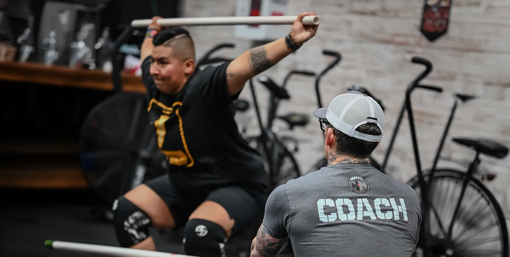 man training with his personal trainer at CrossFit Warehouse